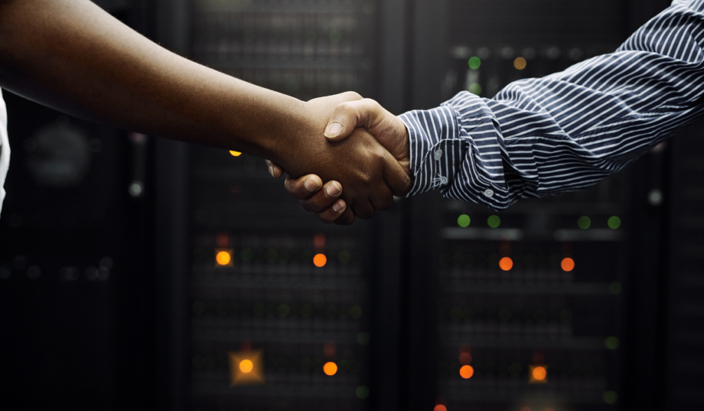 IT service technician shaking the hand of a business owner