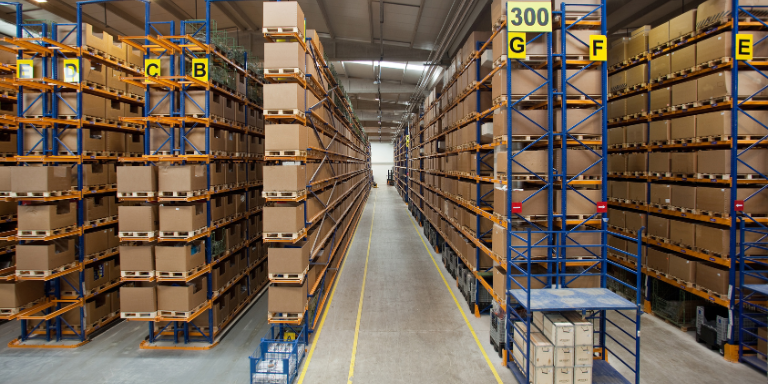 An image of many stacked boxes within a food manufacturing warehouse.