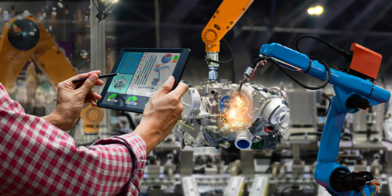 A manufacturing plant employee operating machinery using a smart tablet.