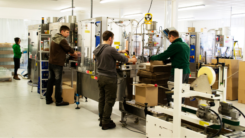 A Michigan manufacturing team using IT systems on production line.