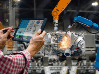 A manufacturing plant employee operating machinery using a smart tablet.