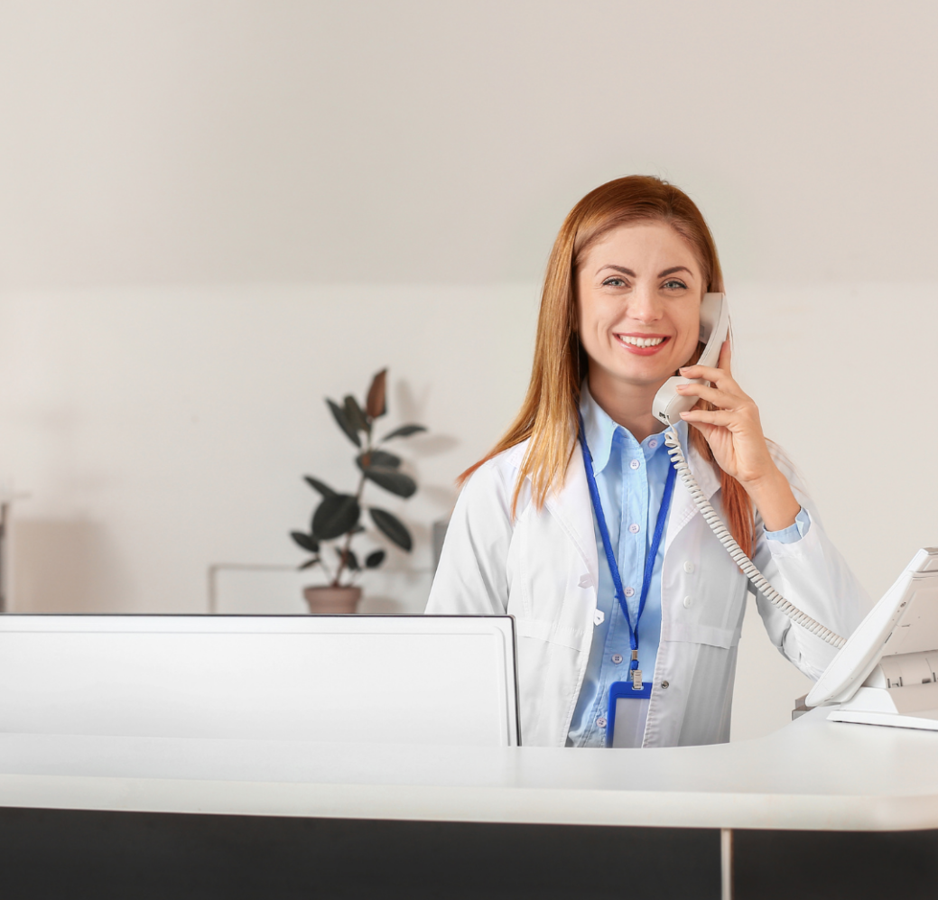 young woman talking on VoIP phone system in medical office