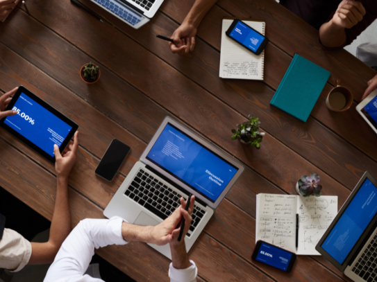 A team of professionals working within a modern office space- enjoying quick internet resulting from good IT support.